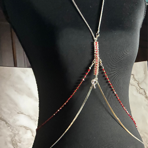 Beaded body chain on a mannequin against a marble background